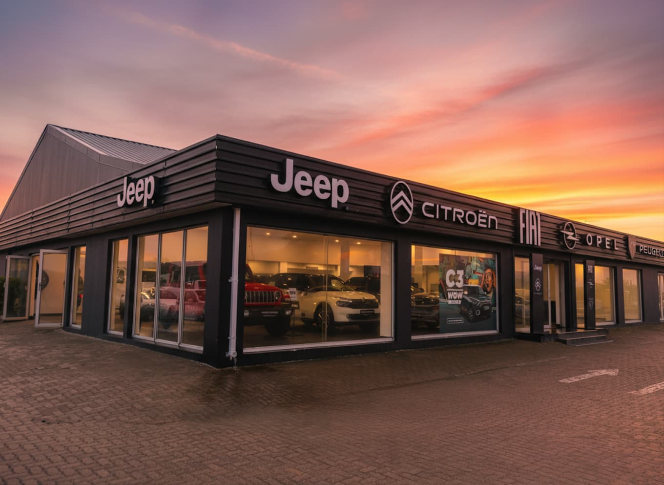 Stellantis Richards Bay dealership at sunset, showing the Jeep, Citroen, Opel and Peugeot brand signage